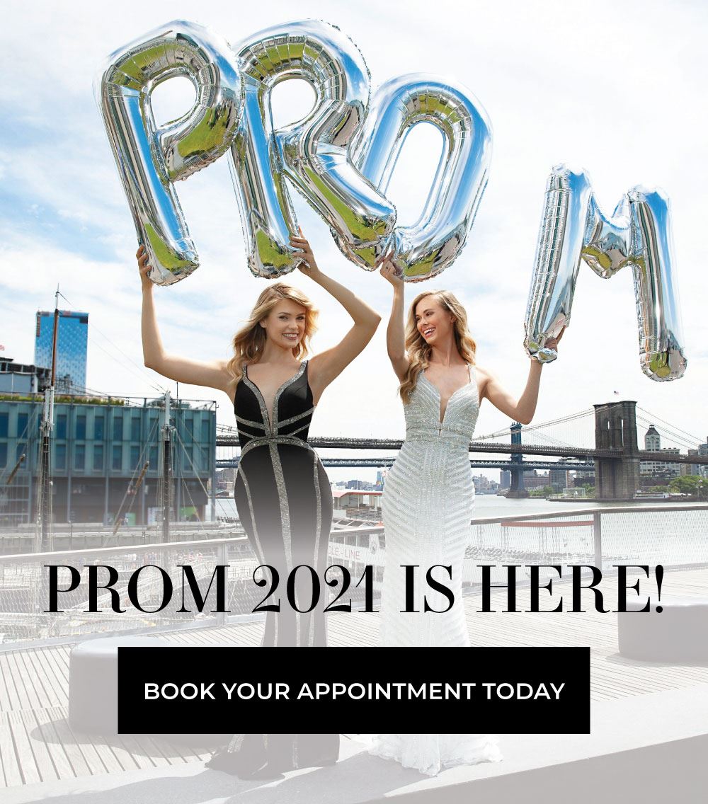 Two girls in prom dresses holding balloons that spell out "prom"