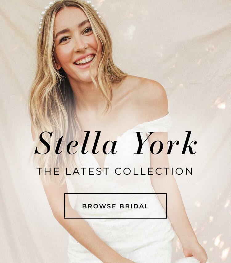Woman with blonde hair wearing a Stella York wedding gown